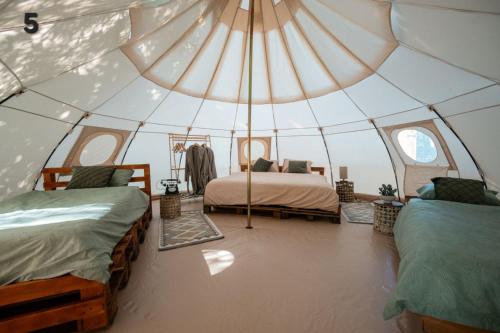 a room with two beds in a tent at Glamping Riverside Skadar lake in Železnička Stanica Zeta