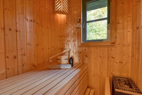 a wooden room with a staircase in a wooden cabin at Ferienhaus Strandbude Feriendorf 32 Klein Stresow Rügen by ruyastay in Putbus