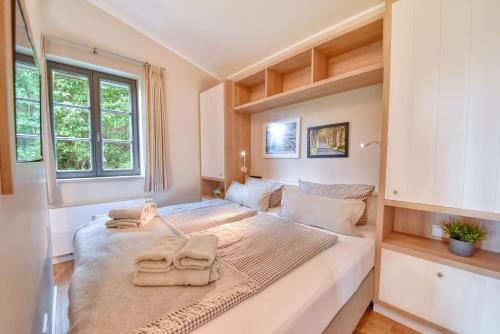 two beds in a small room with towels on them at Ferienhaus Lotta Feriendorf 29 Klein Stresow Rügen by ruyastay in Putbus