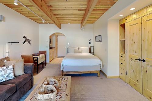 a bedroom with a bed and a couch at Timberline Condominiums Studio Deluxe Unit 215 in Snowmass Village