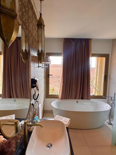 a bathroom with a large tub and a sink at Ksar Sultan Dades - Dades Valley Retreat in Boumalne Dades