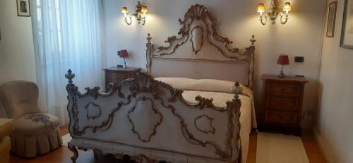 an ornate bed in a bedroom with a dresser at Dimora Da Castello Lago Maggiore in Gravellona Toce