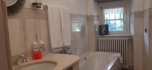 a bathroom with a sink and a bath tub and a sink at Dimora Da Castello Lago Maggiore in Gravellona Toce