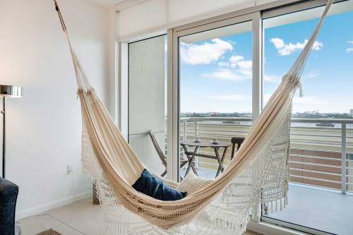 a hammock in a living room with a view at Palm Place Heart of Miami with Parking Pool and Gym in Miami