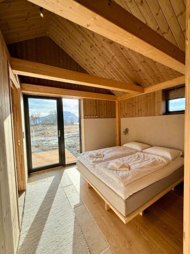 a bedroom with a large bed in a wooden room at Storøya Lodge Lofoten in Vestvågøya