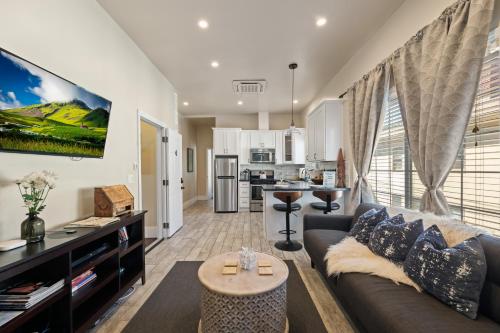a living room with a couch and a kitchen at Upscale 1890s Historic Apartment in Sacramento