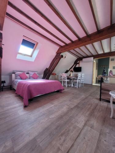 a bedroom with a large bed in a attic at La Maison Au 1894 bulles de bonheur et Spa in Avize