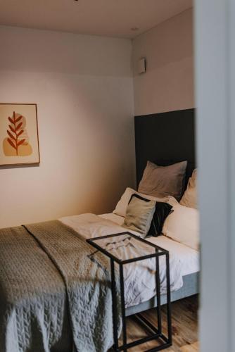 a bedroom with a bed and a table next to it at BnB MAVIE & Whirlpool in Ingolstadt