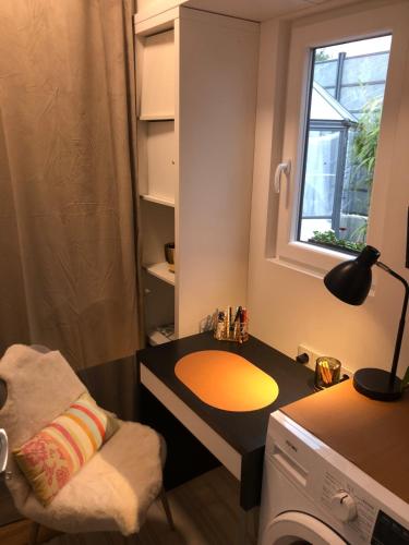 a room with a desk with a lamp and a window at BnB MAVIE & Whirlpool in Ingolstadt