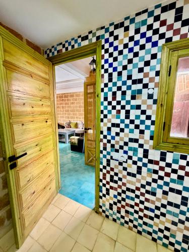 a room with checkered tiles on the wall at Oualidia surflodge in Oualidia