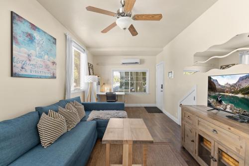 a living room with a blue couch and a tv at Marvelous Midtown Stay with a Modern Twist in Sacramento