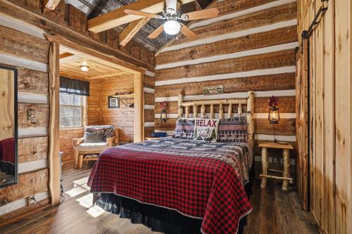 a bedroom with a bed in a room with wooden walls at Creekside Hideout in Cosby