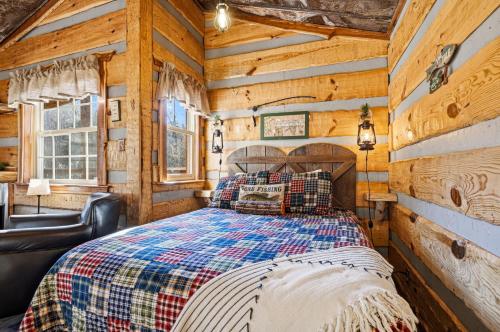 a bedroom with a bed in a room with wooden walls at Creekside Treehouse in Cosby