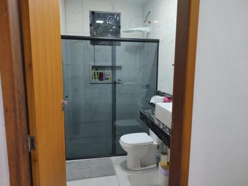 a bathroom with a shower and a toilet and a sink at Eloá Mar's Corner in Angra dos Reis