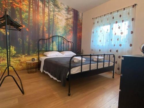 a bedroom with a bed with a painting on the wall at Villa Oaza in Bar
