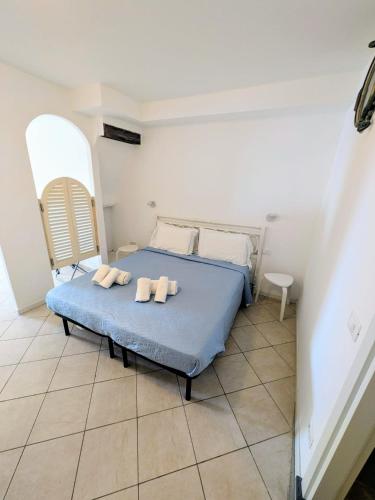 a bedroom with a bed with two towels on it at Back in Tide , frontal sea view window, no AC, Pet friendly in Riomaggiore