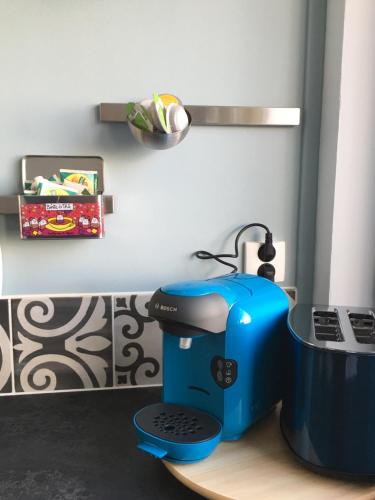a blue sewing machine sitting on top of a table at Mon Appart A GERLAND II in Lyon