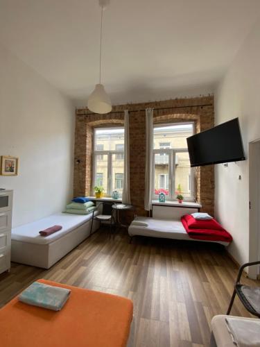 a living room with two beds and a table at Stacja Centrum in Częstochowa