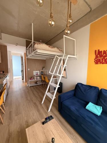 a living room with a blue couch and a bunk bed at Loft en Chapinero con todo lo que necesitas ! in Bogotá