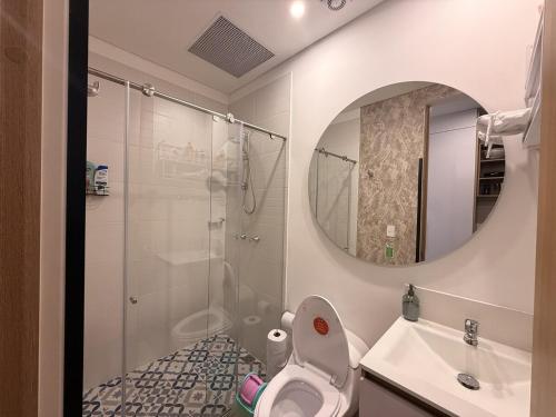 a bathroom with a toilet and a sink and a mirror at Loft en Chapinero con todo lo que necesitas ! in Bogotá