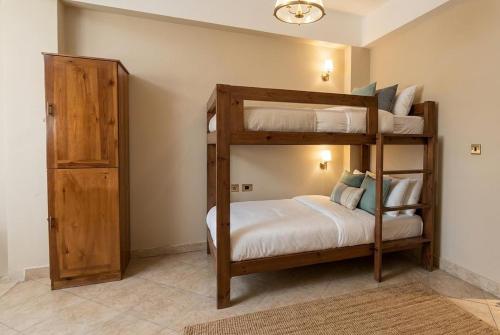 a bedroom with two bunk beds and a closet at Alaska Camp & Hotel in Dahab