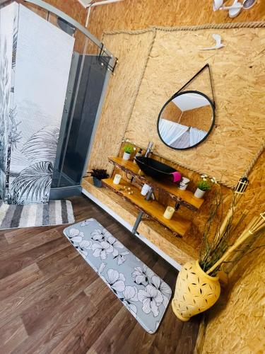 a room with a bathroom with a mirror and a sink at Ô Balcon in Sainte-Rose