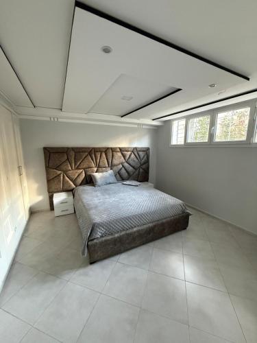 a bedroom with a large bed in a room at Exceptional Villa Pool in Oujda