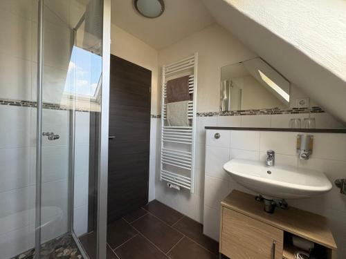 a bathroom with a sink and a shower at Gästehaus Eifelzauber in Kelberg