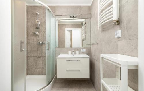 a bathroom with a sink and a shower and a toilet at M-Apartamenty in Kołobrzeg