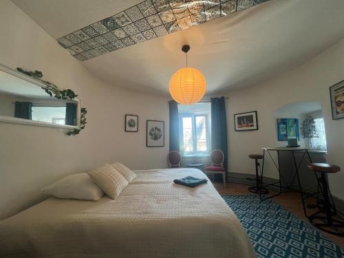a bedroom with a large bed and a lamp at 18 Steps to a Secret Tower in Porrentruy
