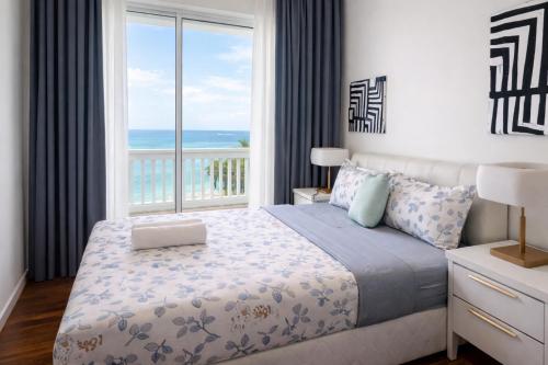 a bedroom with a bed and a large window at Straits Quay Seafront Suite l Panoramic Seaview in Tanjong Tokong