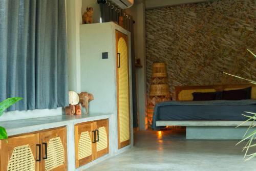 a living room with a bed and a window at BUKU BUKU by Bara Beach in Galle
