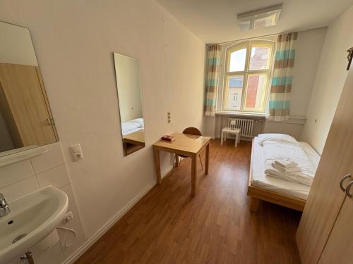 a small room with a bed and a sink at Haus St Vinzenz in Berlin