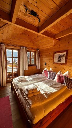 a bedroom with a large bed in a wooden room at st martin chalets in Sankt Michael im Lungau
