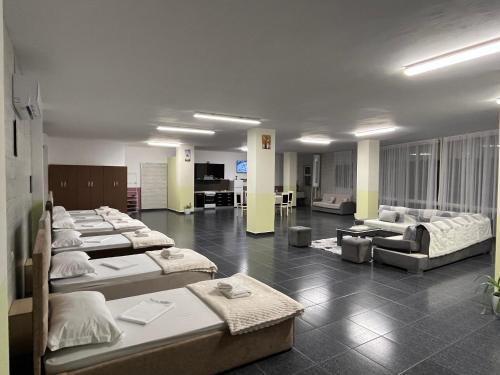 a room with a bunch of beds in it at House Leon in Krujë