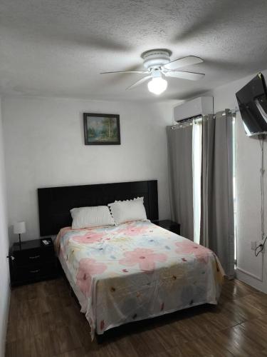 a bedroom with a bed and a ceiling fan at Casa completa en Puente Moreno Ver in Playa de Vacas