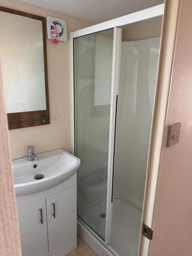 a bathroom with a shower and a sink at Golden Anchor 6 Berth Caravan, Chapel St Leonards, 22 Wild Flower Meadow in Chapel Saint Leonards