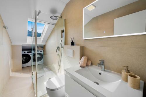 a bathroom with a sink and a toilet at Mirante in Mokošica