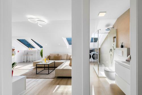 a white living room with a couch and a table at Mirante in Mokošica