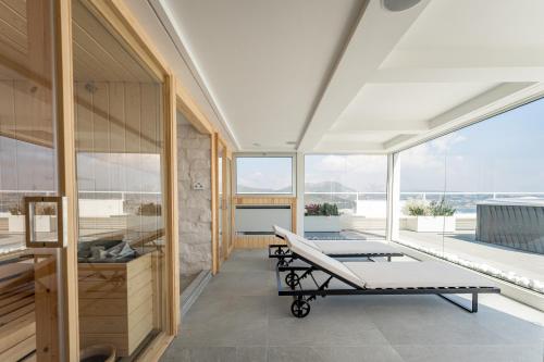 a room with two beds and large windows at Hotel Il Gabbiano in Bacoli