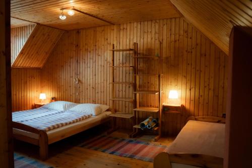 a bedroom with a bed in a wooden room at Privat Luna in ľubeľa