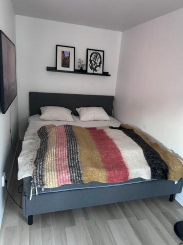 a bedroom with a bed with a colorful blanket on it at Casa Båstad in Båstad