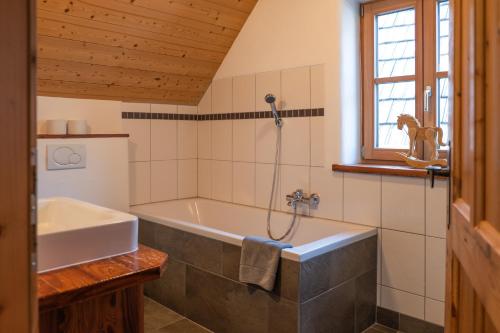 a bathroom with a tub and a sink at st martin chalets in Sankt Michael im Lungau
