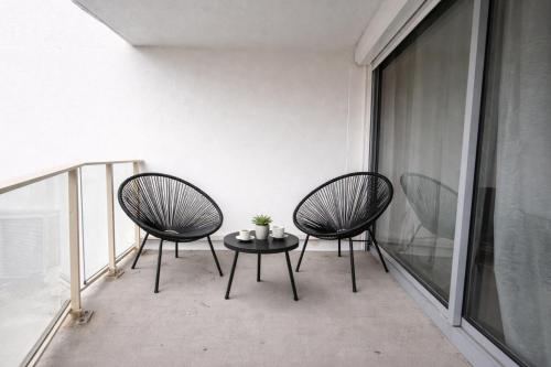 two chairs and a table on a balcony at centre port le cocon 4 couchages in Cap d'Agde