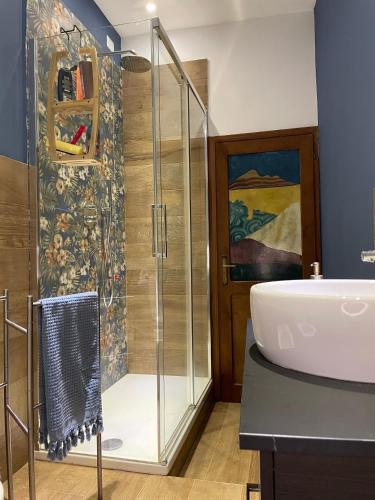 a bathroom with a glass shower and a sink at Arkham Casa Vacanze in Amelia