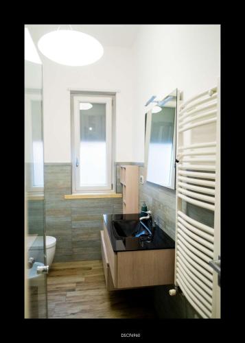 a bathroom with a sink and a toilet at Casa Porta D'Amalfi vicino Stazione e terminal Sita Salerno in Salerno