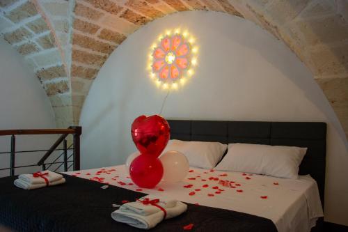 a room with a bed with balloons on it at Hesperia Suite - Jacuzzi & Garden in Corigliano dʼOtranto