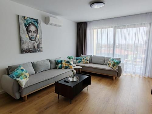 a living room with a couch and a table at Sunny apartment208 in Dunajská Streda
