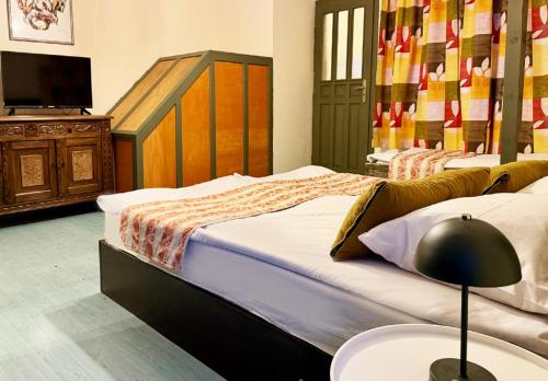 a bedroom with two beds and a table with a lamp at Къща за гости Арт Спектър in Bratsigovo