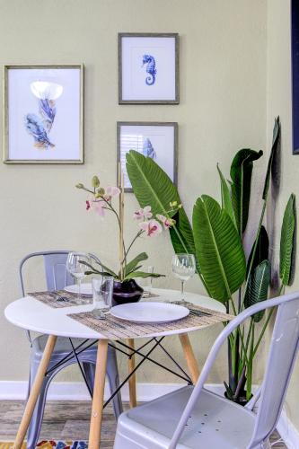 a dining room table with chairs and plants at Peaceful Retreat in Gated Midtown Community in Memphis